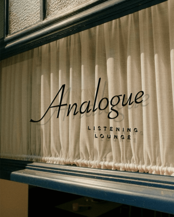 A mockup of the Analogue logo printed on a restaurant window.